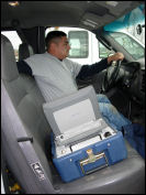 Man in car with meter reading equipment